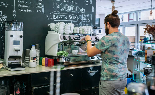 Male barista preparing coffee machine