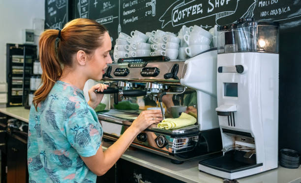 istock Female barista preparing coffee machine 1269264570