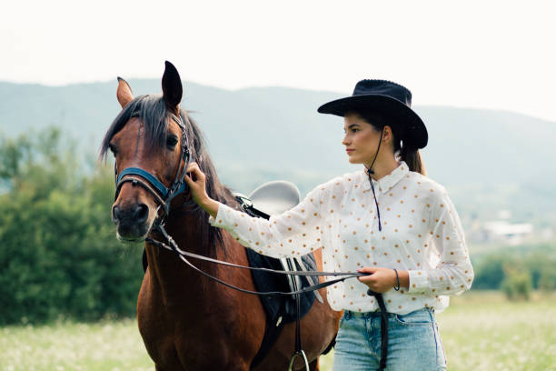 istock Young women rides a horse 1269265556