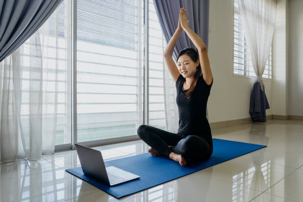 istock Young asian woman working out at home using laptop 1269266033