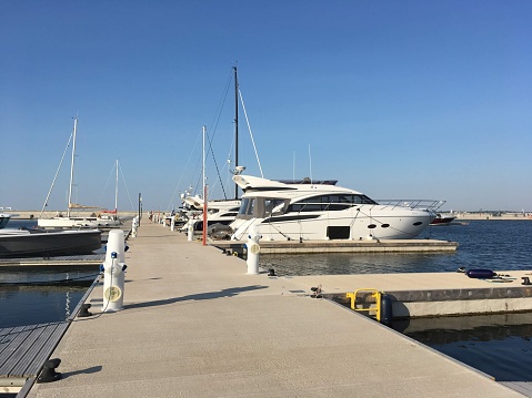 Puerto Andratx, Spain -April 14, 2024: View at the Puerto Andratx harbor at a boat dock at the night time. The harbor in Puerto Andratx, Mallorca, is renowned for its affluent international visitors, whether tourists or residents, especially during sunset and for its pub nightlife.