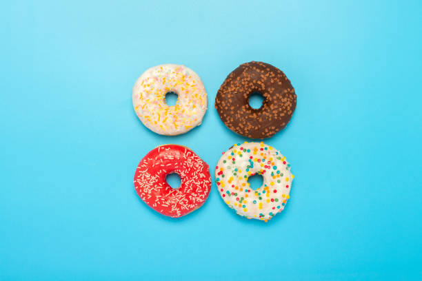 istock Donuts of different types on a blue background. Concept of sweets, bakery,. Banner. Flat lay, top view 1269271731