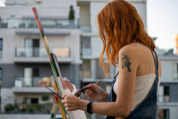 istock girl painter paints in the garden 1269272893