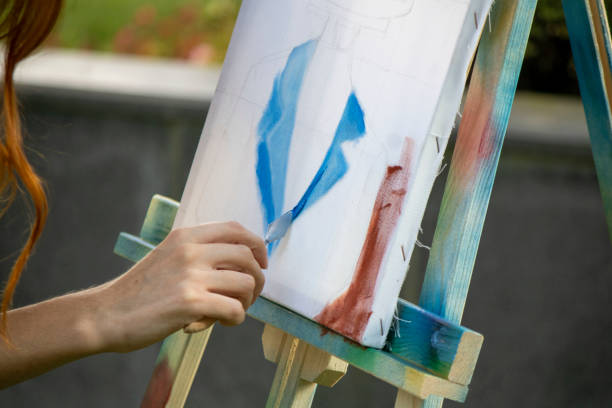 istock girl painter paints in the garden 1269273078