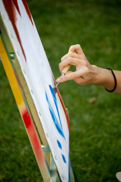 istock girl painter paints in the garden 1269273086