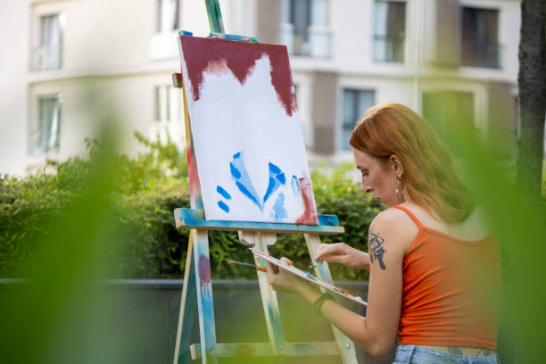 istock girl painter paints in the garden 1269273099