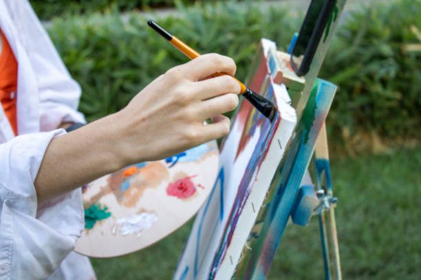 istock girl painter paints in the garden 1269273169