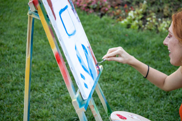 istock girl painter paints in the garden 1269273237