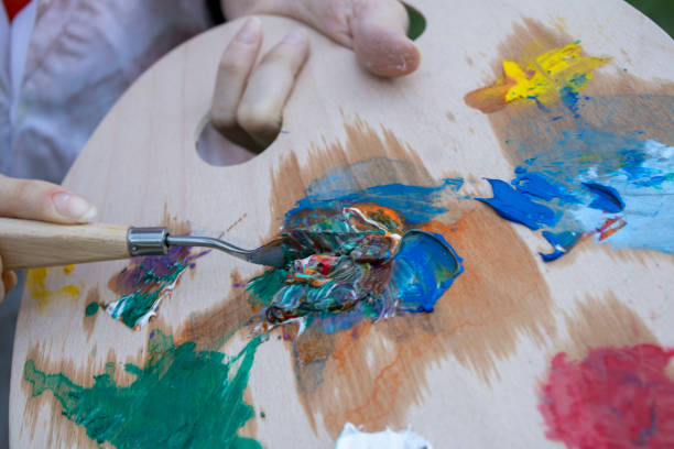 istock girl painter paints in the garden 1269273253