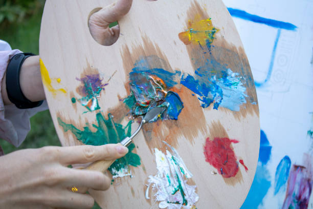istock girl painter paints in the garden 1269273340