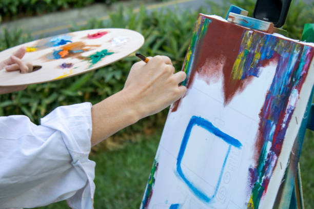 istock girl painter paints in the garden 1269273402