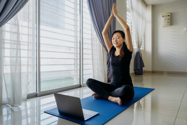 istock Young asian woman working out at home using laptop 1269274129