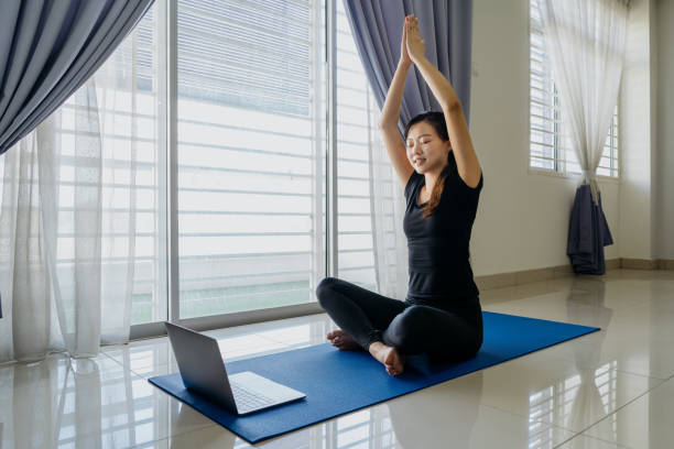 istock Young asian woman working out at home using laptop 1269274133