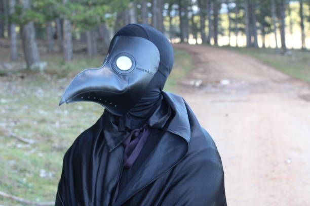 istock Plague doctor walking in the forest 1269276762