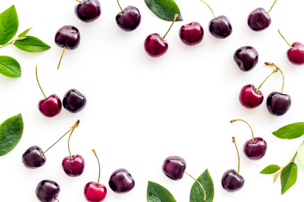 istock Frame of red cherries, berries background. Overhead view 1269277154