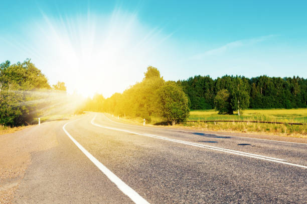 istock Country asphalt road, green fields and forest at summer 1269279974