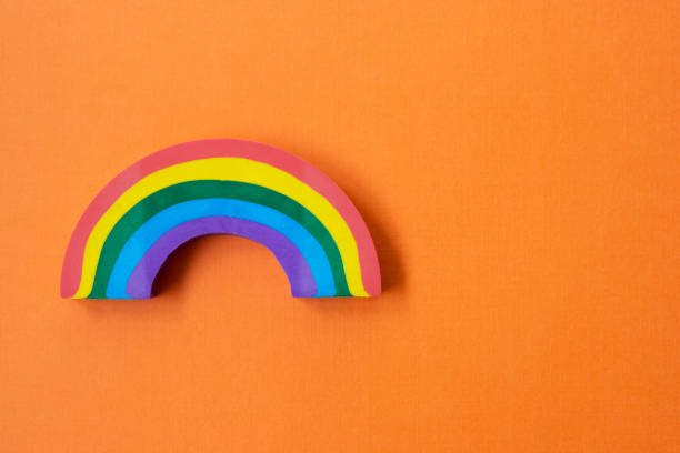 istock Rainbow object, over orange background. LGBT concept. Education background with copy space. 1269280033