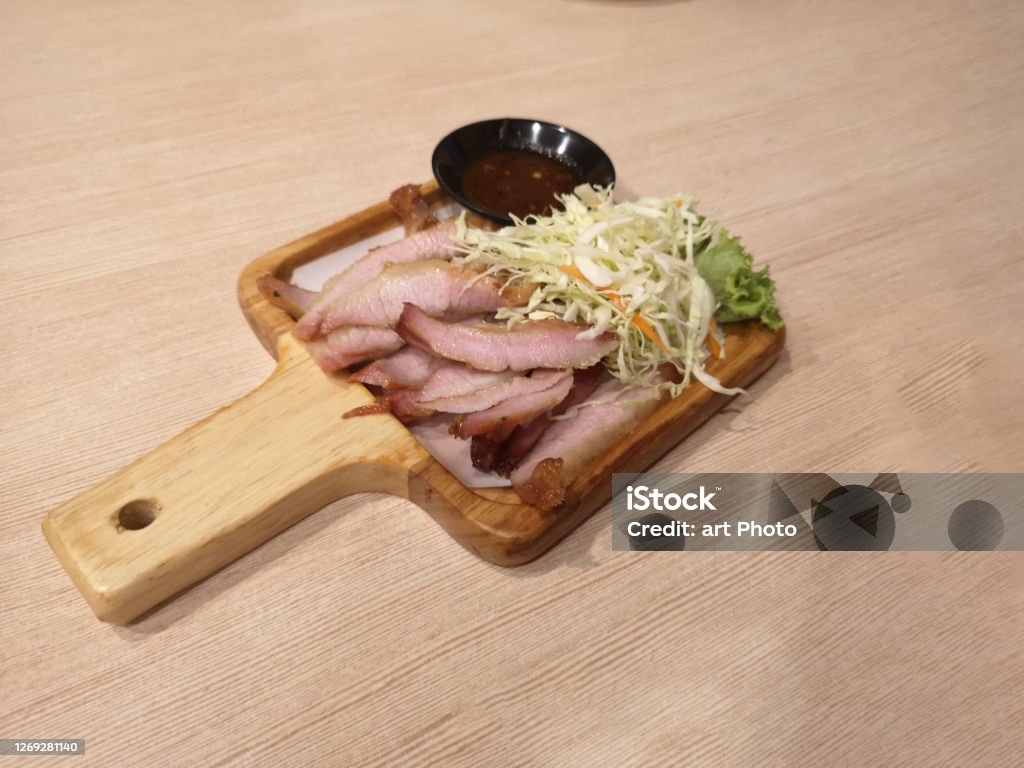 Charcoal boiled pork neck with sweet chili sauce and Cabbage, finely sliced on wooden tray, Thai food Fragrant soft deliciou Charcoal boiled pork neck with sweet chili sauce and Cabbage, finely sliced on wooden tray, Thai food Fragrant soft delicious Barbecue - Meal Stock Photo