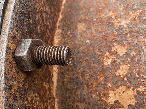 Big rusty metal nuts locked with rust,Close-Up Of Old Rusty Metal,Rusty old industrial screw nut and bolt.