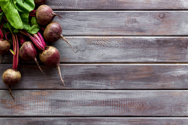 istock Beet - fresh, with leaves - on wooden table top view copy space 1269283774