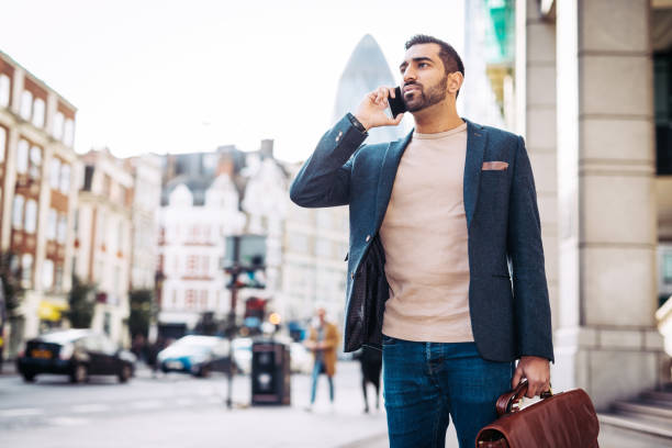 istock Portrait of Indian businessman using smart phone in city 1269284607