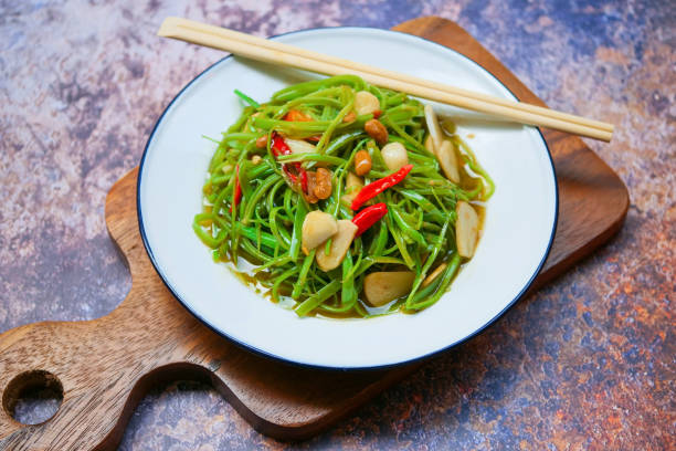 Sliced morning glory sauteed with oyster sauce, chilli and garlic stock photo