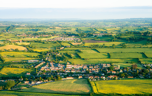 An aerial view of small villages surrounded by traditional hedge-enclosed fields in Somerset, England.