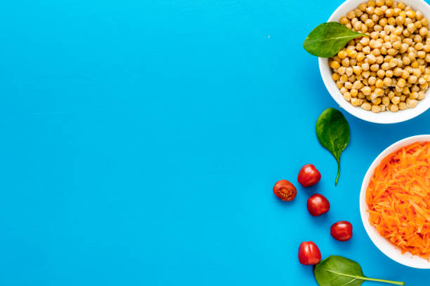 Vegetarian bowl with chickpeas and vegetables on table top view.