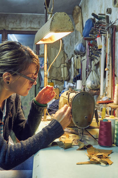 istock Woman tailor using retro sewing machine at home, hobby concept. 1269291503