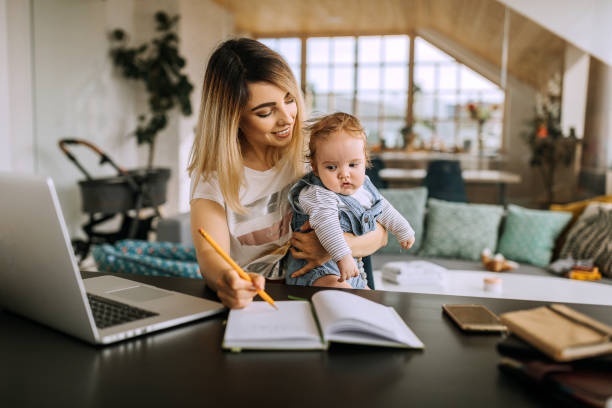 istock Multitasking businesswoman with her son at the  home office 1269293844