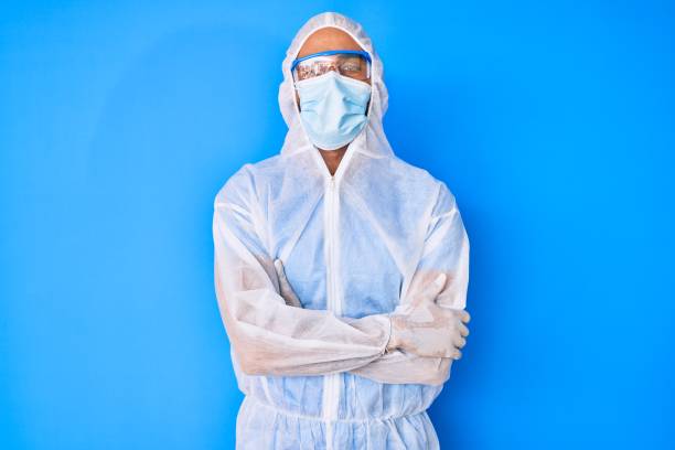 istock Young hispanic man wearing doctor coronavirus protection uniform happy face smiling with crossed arms looking at the camera. positive person. 1269296473
