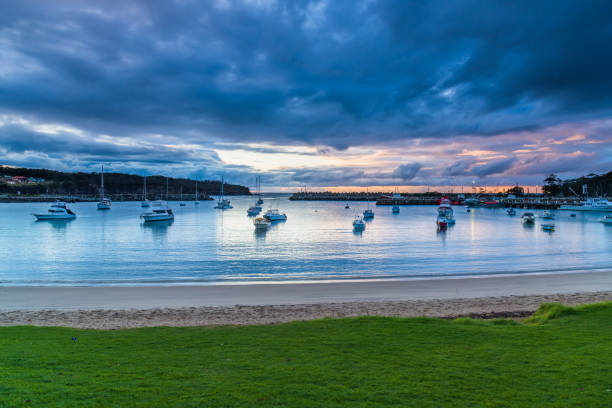 istock Seaside harbour overcast seascape with boats 1269297868