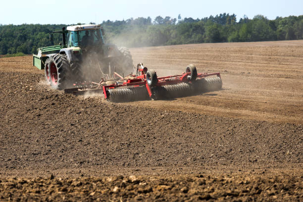 istock a modern tractor plowing an earthy field 1269301315