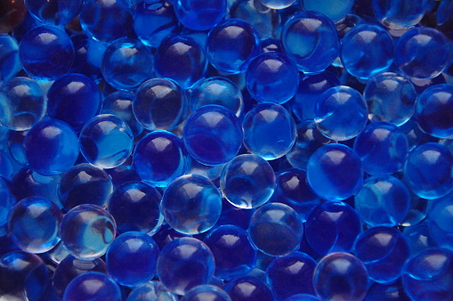Multicolored gel balls. Hydrogel. Glass bead of blue color. Texture or background.