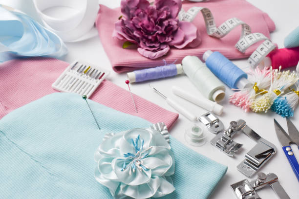 Sewing accessories and spare parts from a sewing machine on a white background top view