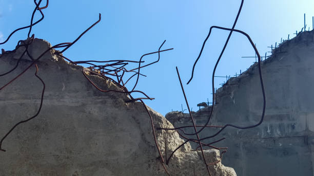 istock Destruction of a concrete structure with reinforcement against a blue sky background. Old concrete floor of an abandoned building 1269307731