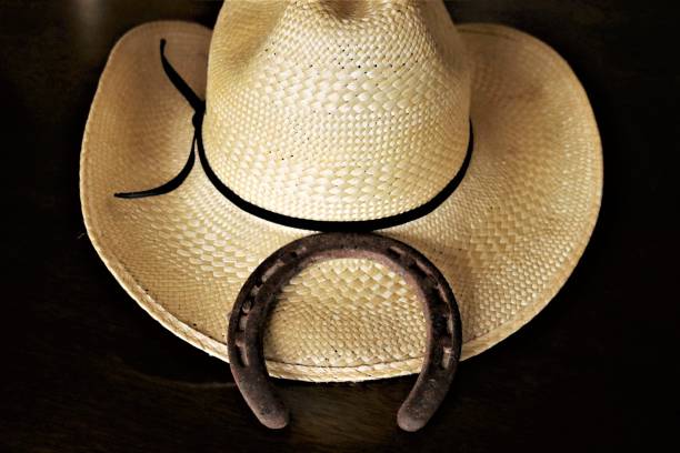 istock Cowboy Hat and Horseshoe on Black 1269309113