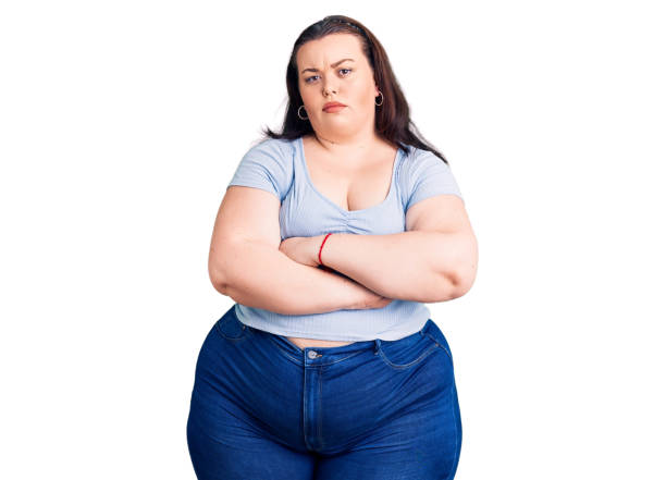 young plus size woman wearing casual clothes skeptic and nervous, disapproving expression on face with crossed arms. negative person. - overweight women serious people imagens e fotografias de stock