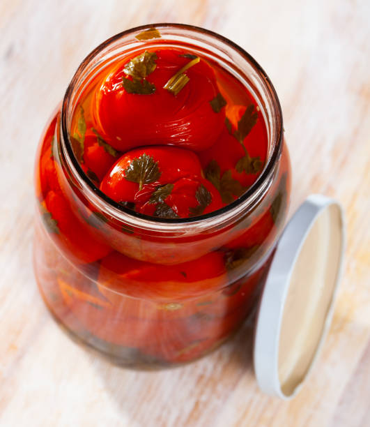 istock Pickled tomatoes in glass jar 1269312162