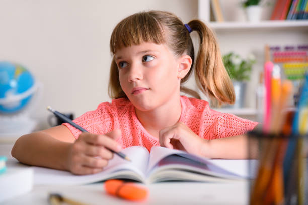 istock Tired girl studying school assignments at home 1269313697
