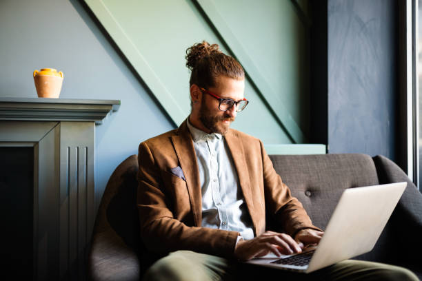 istock Portrait of handsome businessman smiling while using laptop in office 1269313992