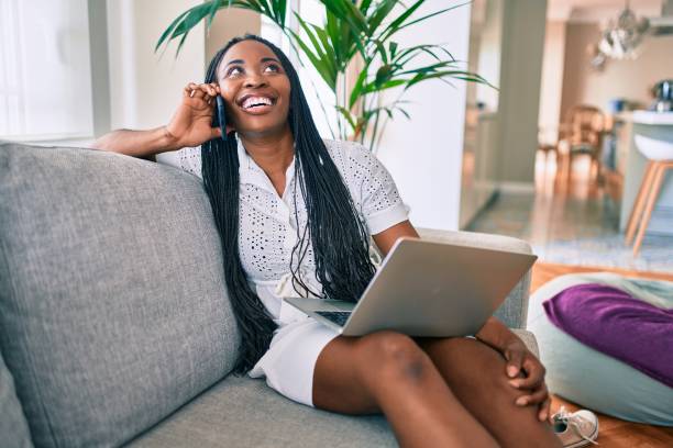 istock Young african american woman smiling happy using smartphone at home 1269314105