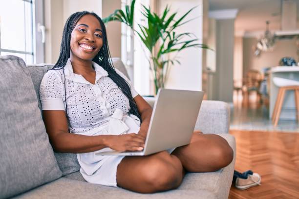 istock Young african american woman smiling happy working using laptop at home 1269314149