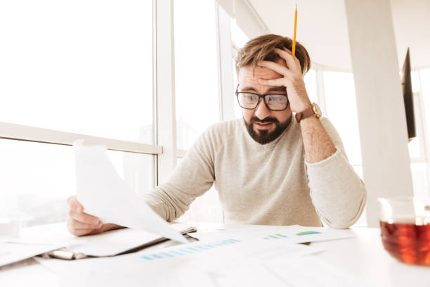 istock Portrait of a disappointed man working with documents 1269318797