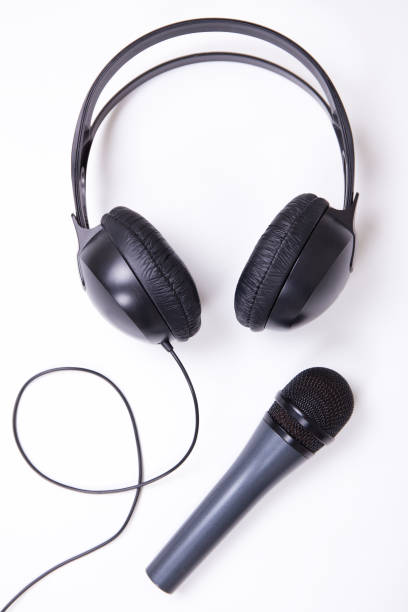 istock music concept - microphone and headphones over white 1269320875