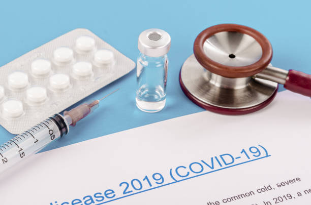 istock Coronavirus disease 2019 with vaccine and pill on blue 1269322330