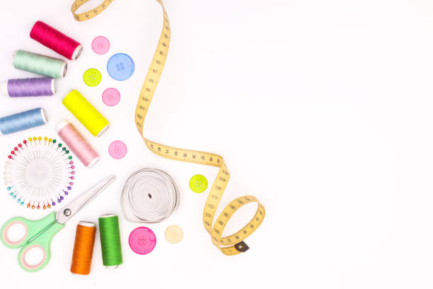 istock Sewing equipment, scissors, ribbons, needles, cottons on white theme 1269325480