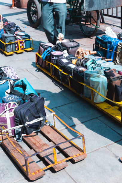 Mumbai, India, 18 november, 2020 / Dabbawala lunchbox or tiffin box delivery service: operators with typical white hat delivering lunchboxes with warm food from home.