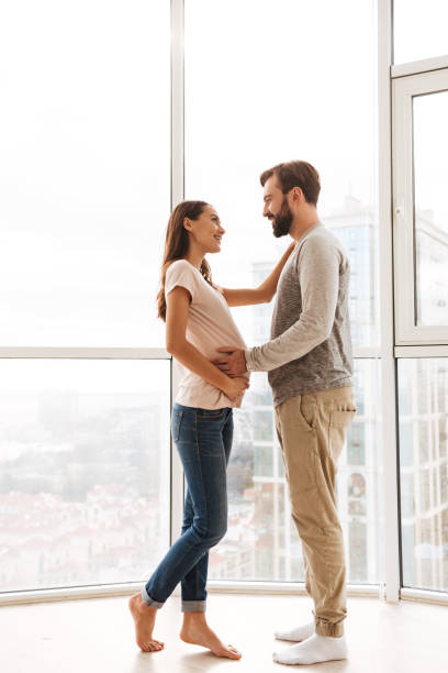 istock Happy pregnant young couple hugging 1269326705