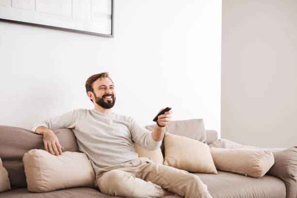 istock Portrait of a happy man holding remote control 1269327018